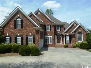 908 Ashford Way Fort Mill, SC 29708 - Photo 1 of 16 a front view of a house with a garden