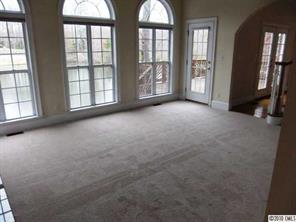 908 Ashford Way Fort Mill, SC 29708 - Photo 9 of 16 an empty room with windows and hallway