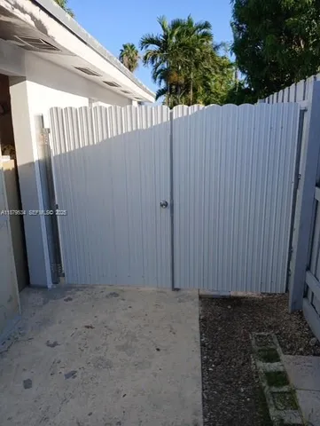 a view of a backyard with wooden fence