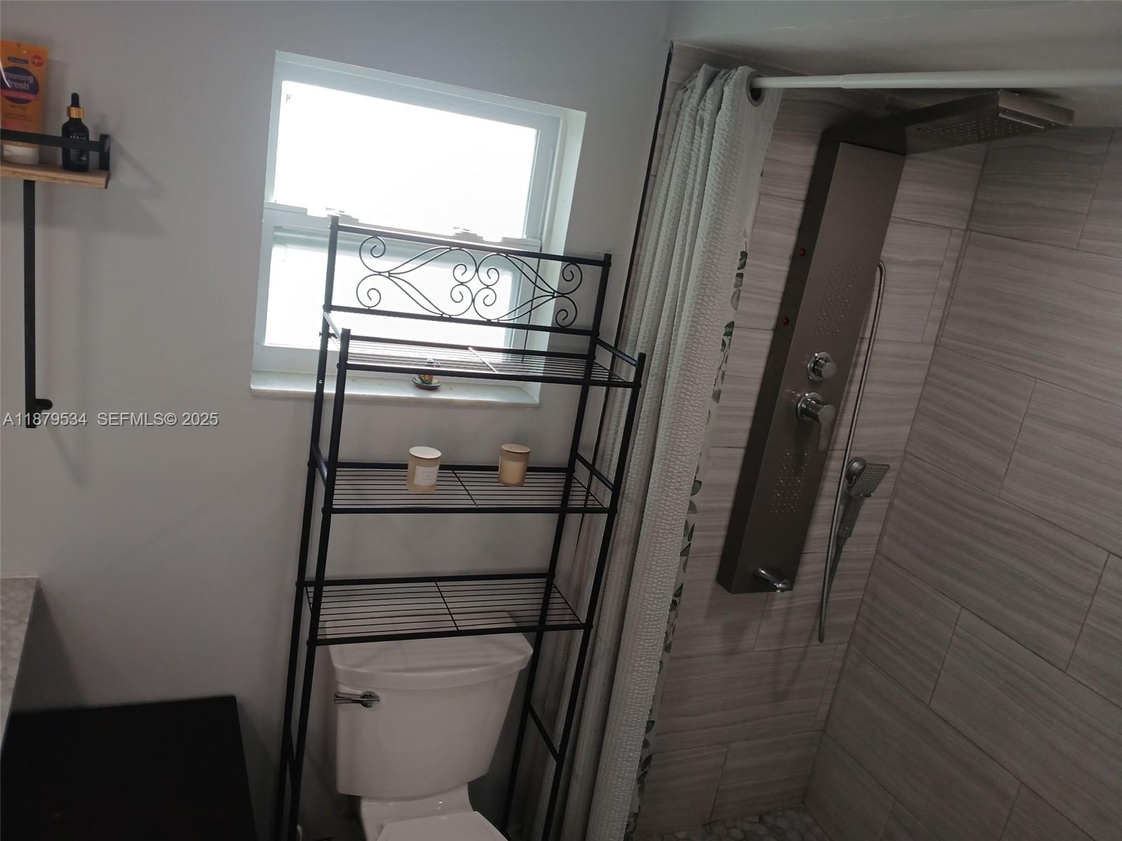 11510 Southwest 182nd Terrace, Unit 2 Miami, FL 33157 - Photo 3 of 7 a bathroom with a glass door shower and toilet