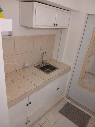 a kitchen with a sink and cabinets