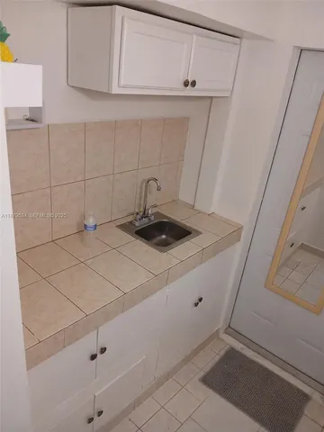 a kitchen with a sink and cabinets