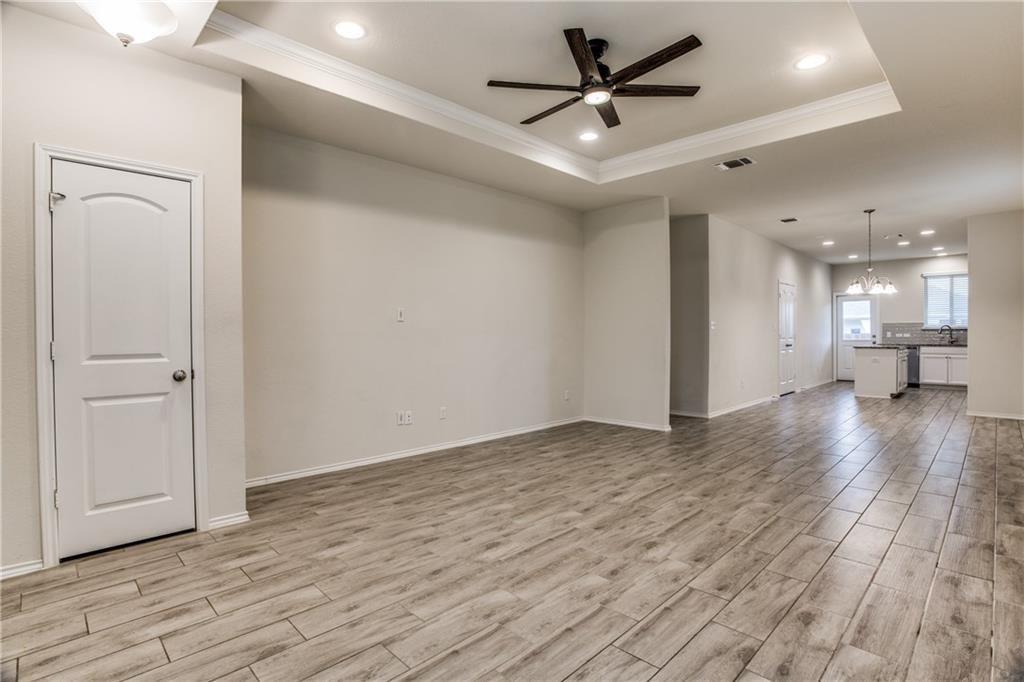 1413 Cliffbrake Way Georgetown, TX 78626 - Photo 4 of 30 a view of a big room with wooden floor and a ceiling fan