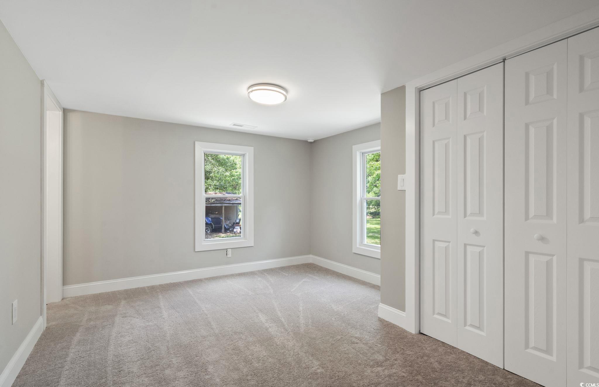 2074 Jem Lane Conway, SC 29527 - Photo 13 of 15 Unfurnished bedroom with light carpet, multiple windows, and a closet