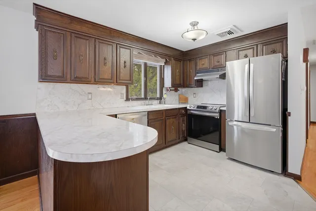 a kitchen with stainless steel appliances a refrigerator sink and cabinets