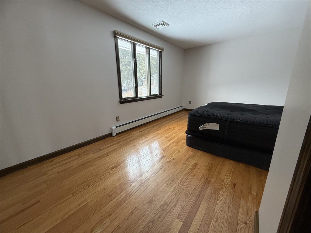 63 Helene Street Ludlow, MA 01056 - Photo 6 of 11 a living room with wooden floor and a window