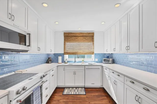 a view of a dining room with furniture wooden floor and a chandelier