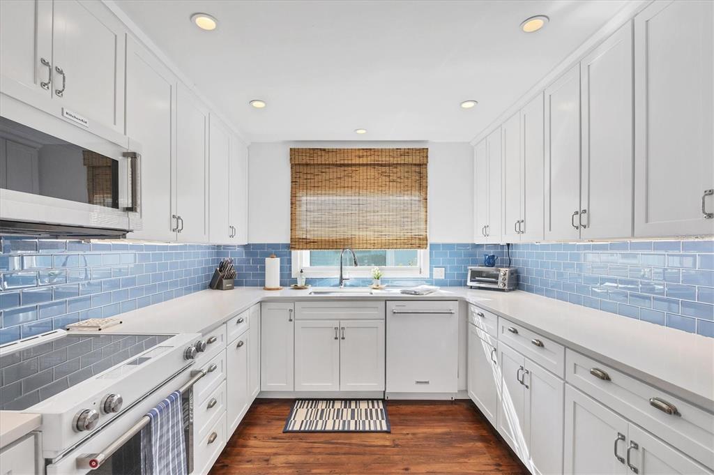 380 Tarpon Avenue Boca Grande, FL 33921 - Photo 12 of 38 a kitchen with a sink stove and cabinets