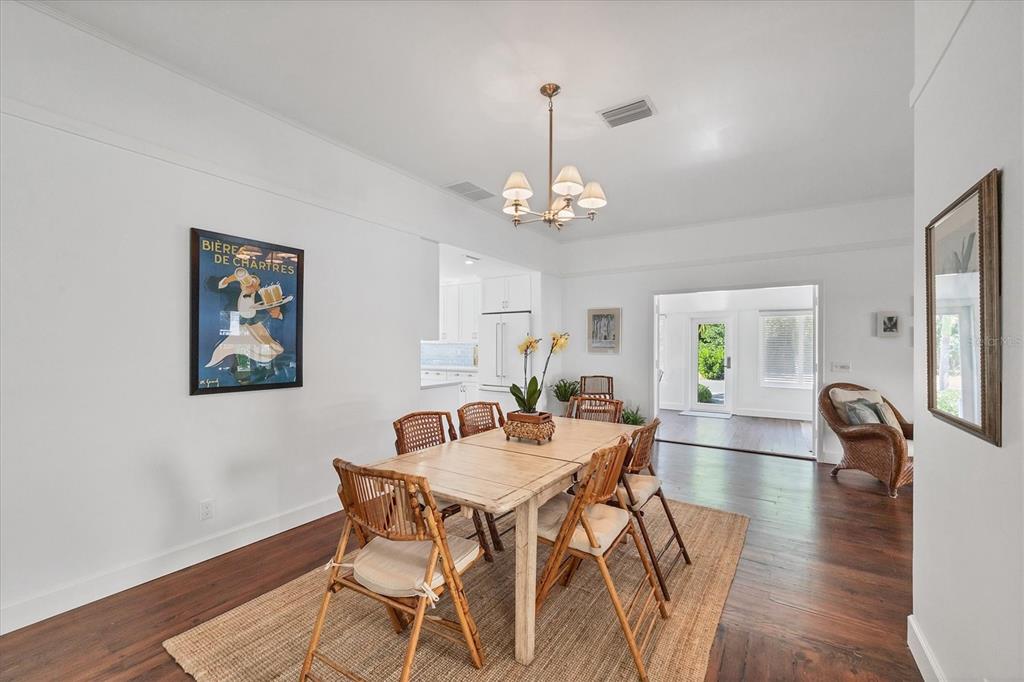 380 Tarpon Avenue Boca Grande, FL 33921 - Photo 17 of 38 a view of a dining room with furniture wooden floor and a chandelier