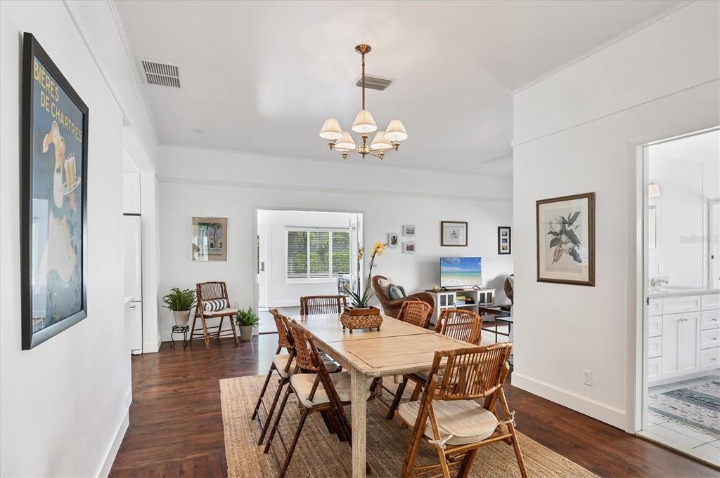 380 Tarpon Avenue Boca Grande, FL 33921 - Photo 18 of 38 a view of a dining room with furniture wooden floor and a chandelier