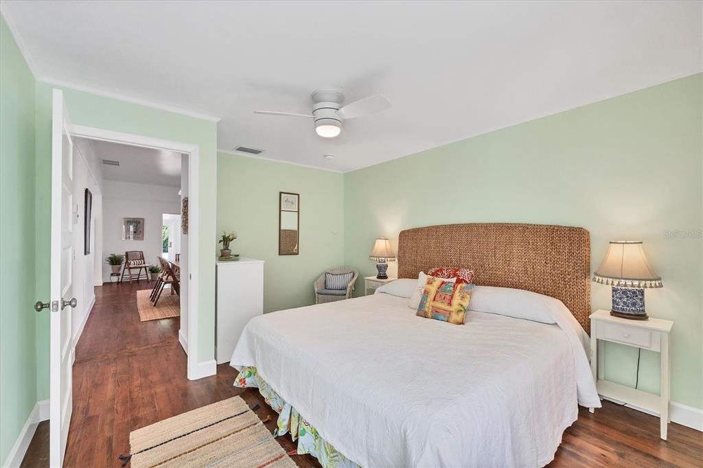 380 Tarpon Avenue Boca Grande, FL 33921 - Photo 19 of 38 a bedroom with a bed and wooden floor