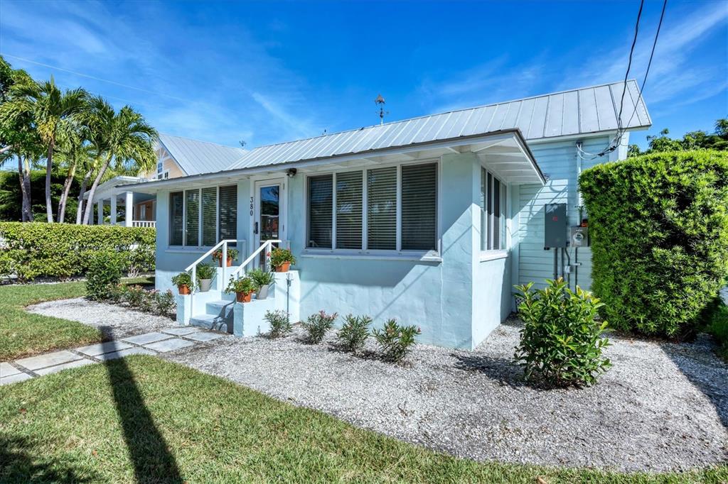 380 Tarpon Avenue Boca Grande, FL 33921 - Photo 2 of 38 a view of a house with backyard sitting area and garden