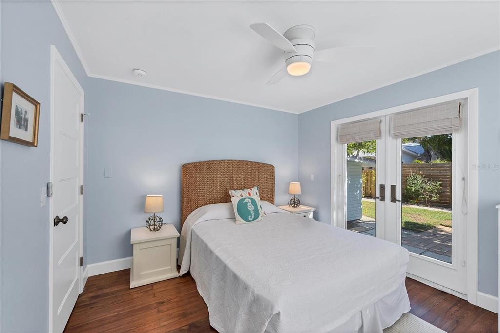 380 Tarpon Avenue Boca Grande, FL 33921 - Photo 24 of 38 a bedroom with a bed and wooden floor