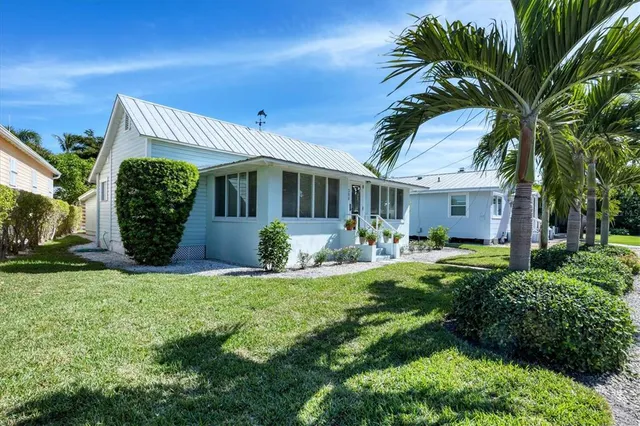 a dining room with furniture large windows and wooden floor