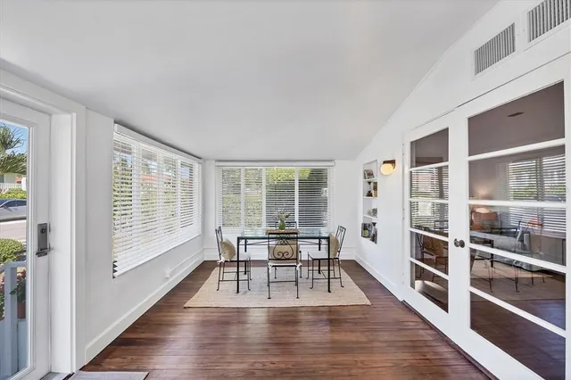 a large white kitchen with stainless steel appliances and white cabinets