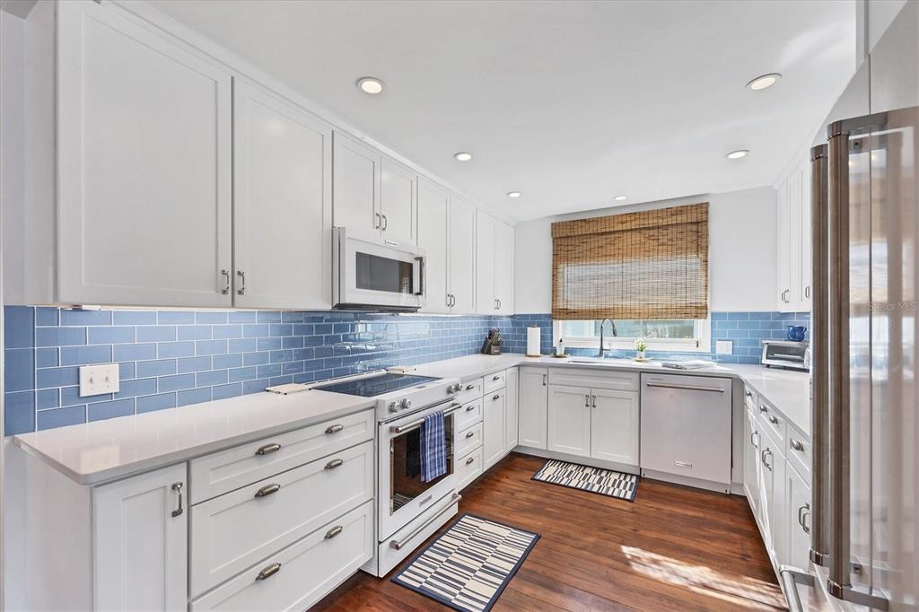 380 Tarpon Avenue Boca Grande, FL 33921 - Photo 10 of 38 a kitchen with a sink stove and cabinets