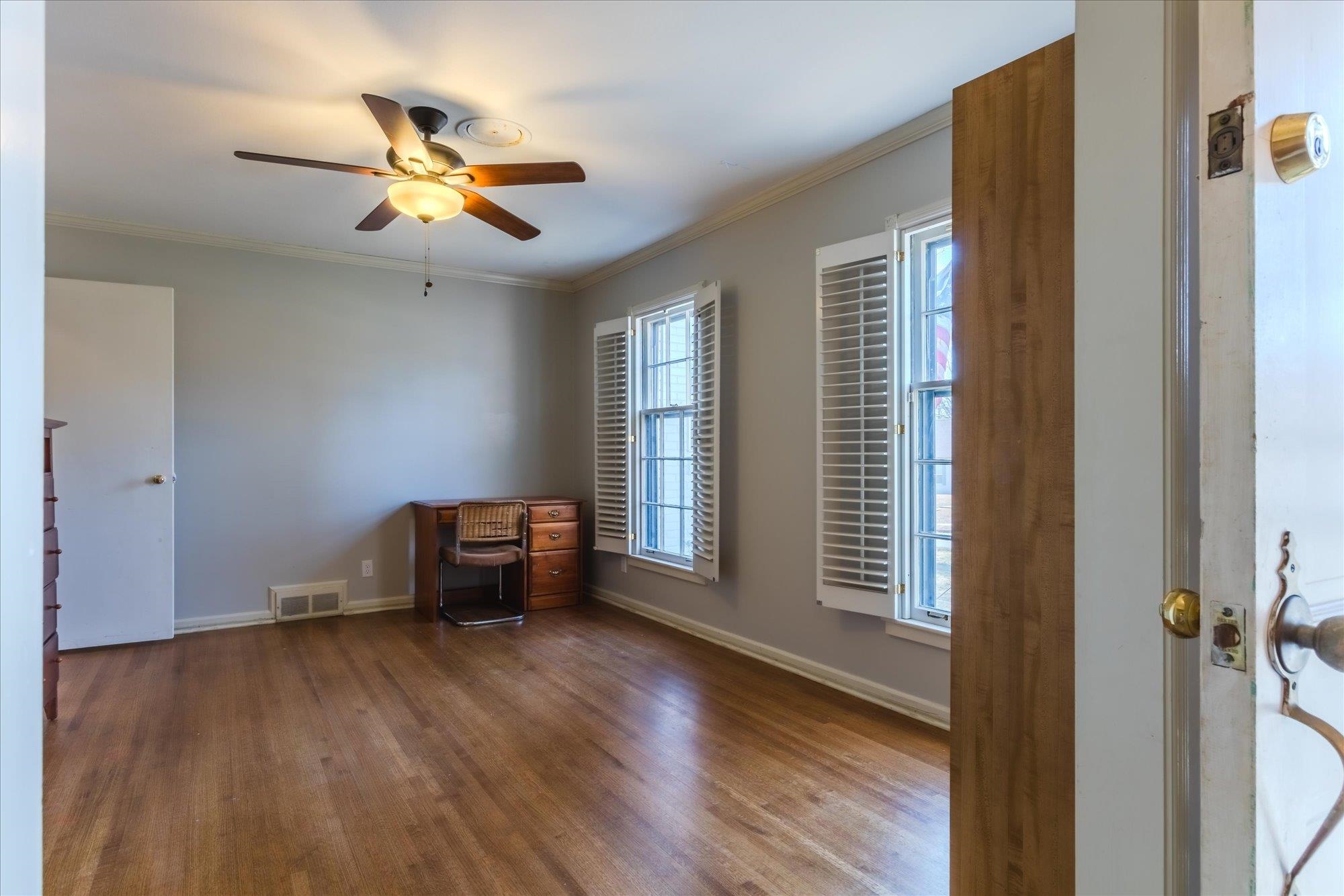 1490 Hayne Road Memphis, TN 38119 - Photo 7 of 33 a view of an empty room with wooden floor and a window