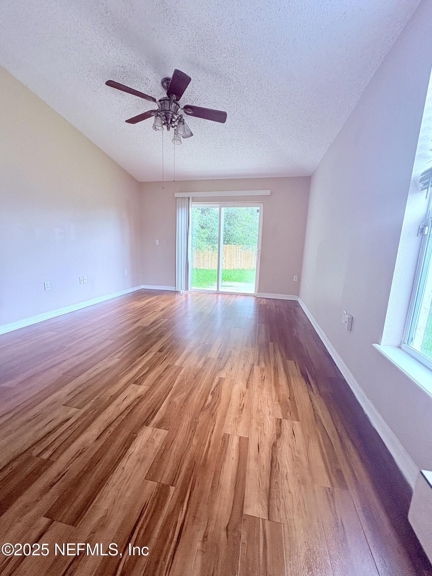 2996 Valkyrie Road Middleburg, FL 32068 - Photo 4 of 9 wooden floor in an empty room with a window