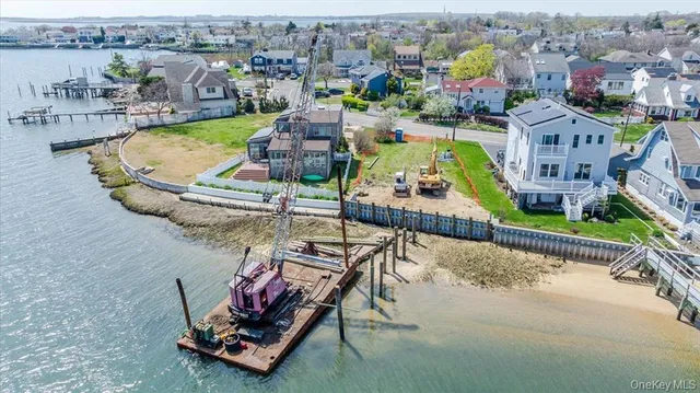 an aerial view of a house with a garden and lake view