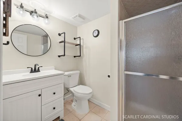 a bathroom with a toilet a sink and a mirror