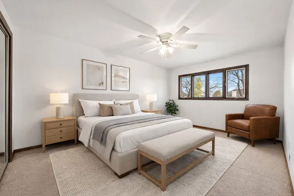 a spacious bedroom with a bed and a couch