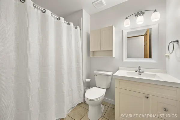 a bathroom with a toilet a sink and a mirror