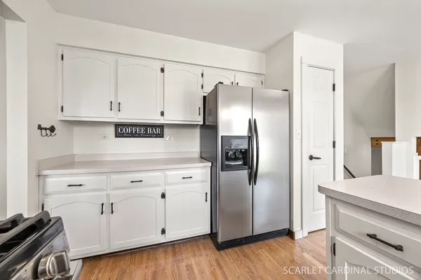 a kitchen with white cabinets and stainless steel appliances