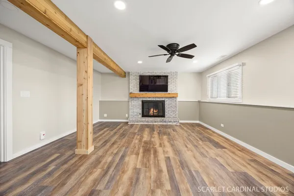 a view of empty room with a fireplace and fan