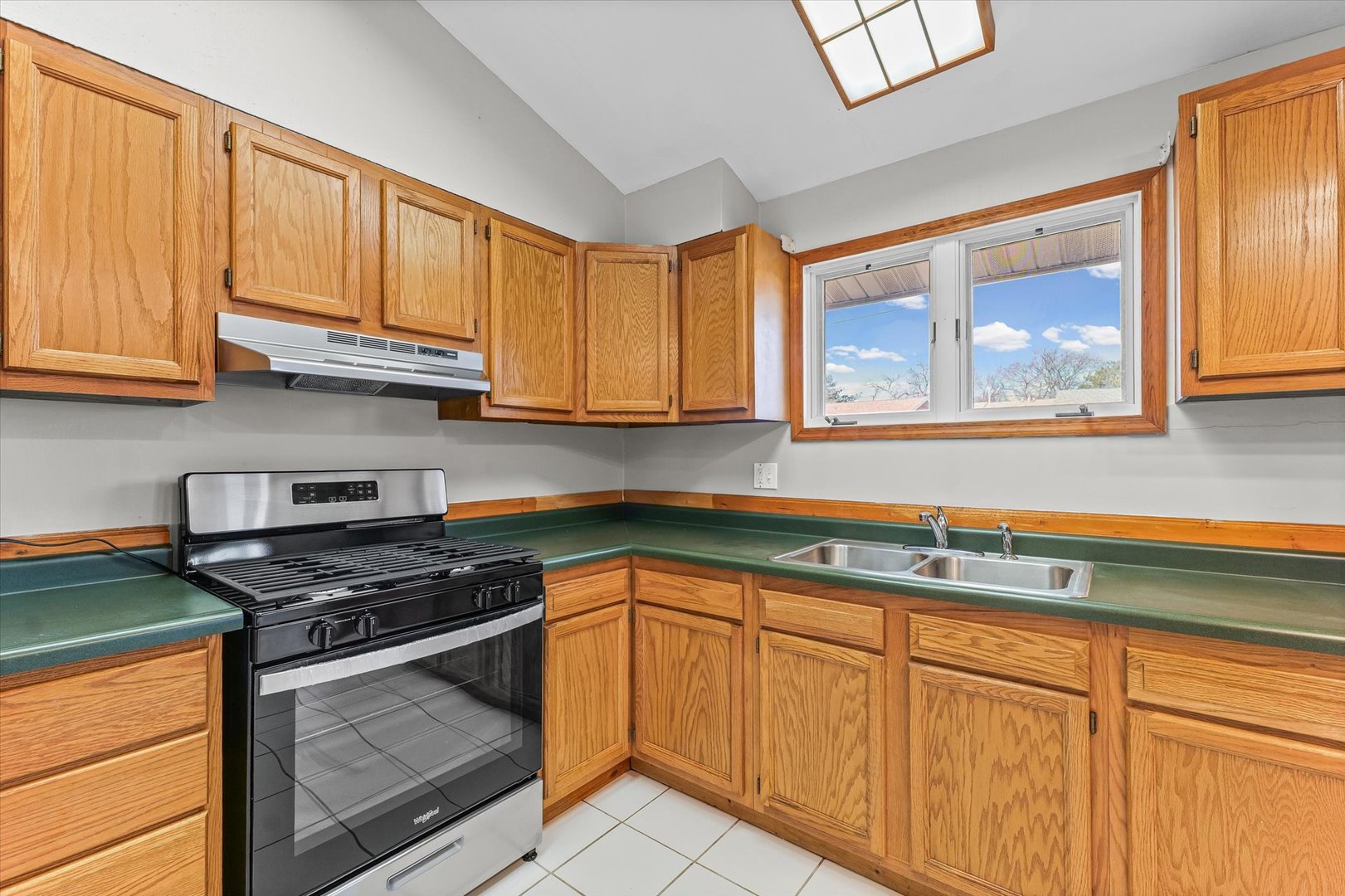 1612 Golfview Road Rantoul, IL 61866 - Photo 12 of 28 a kitchen with granite countertop stainless steel appliances white cabinets granite counter tops and a wooden floors