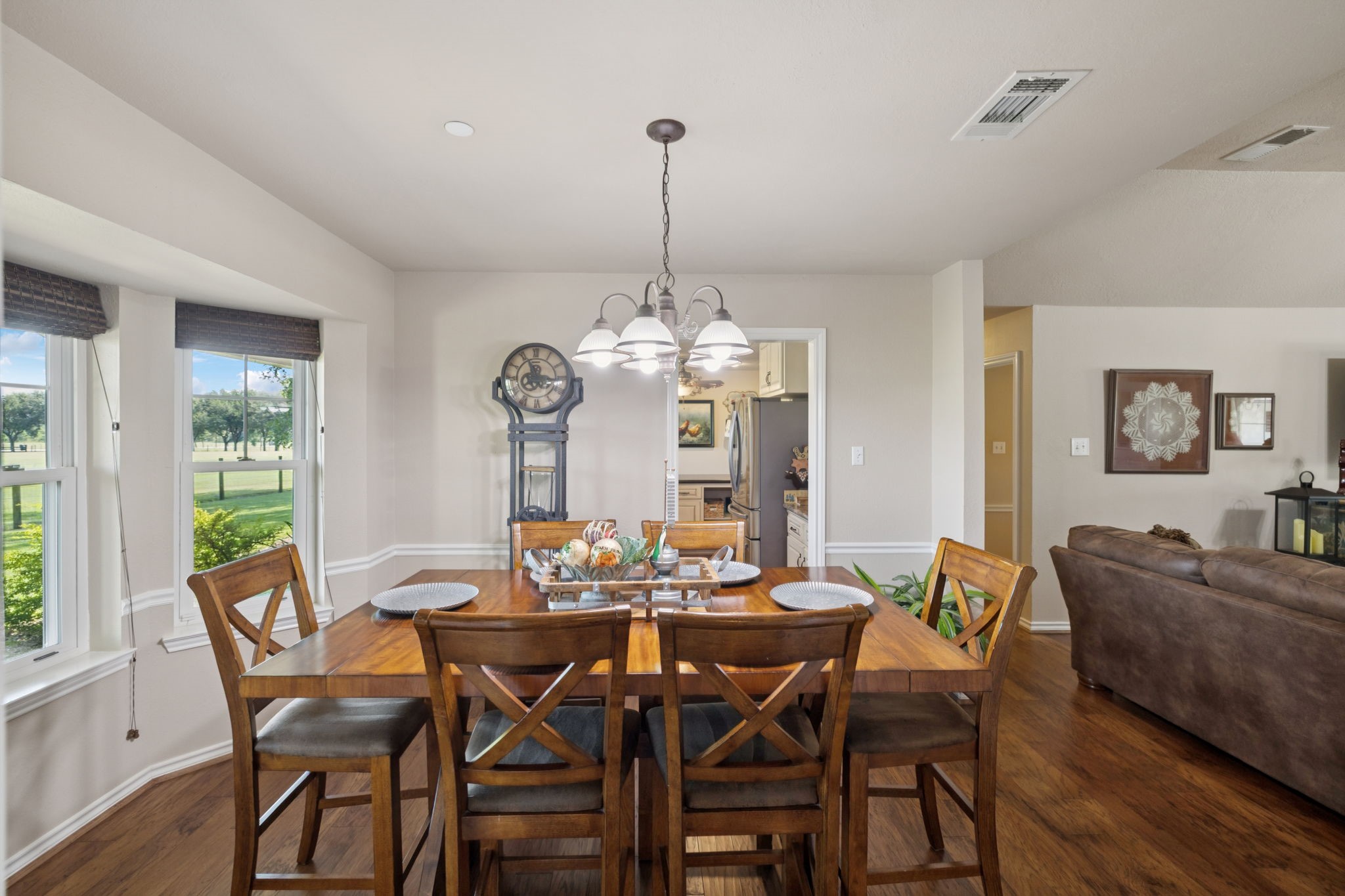 31229 Rochen Road Waller, TX 77484 - Photo 11 of 50 a dining room with furniture a chandelier and wooden floor