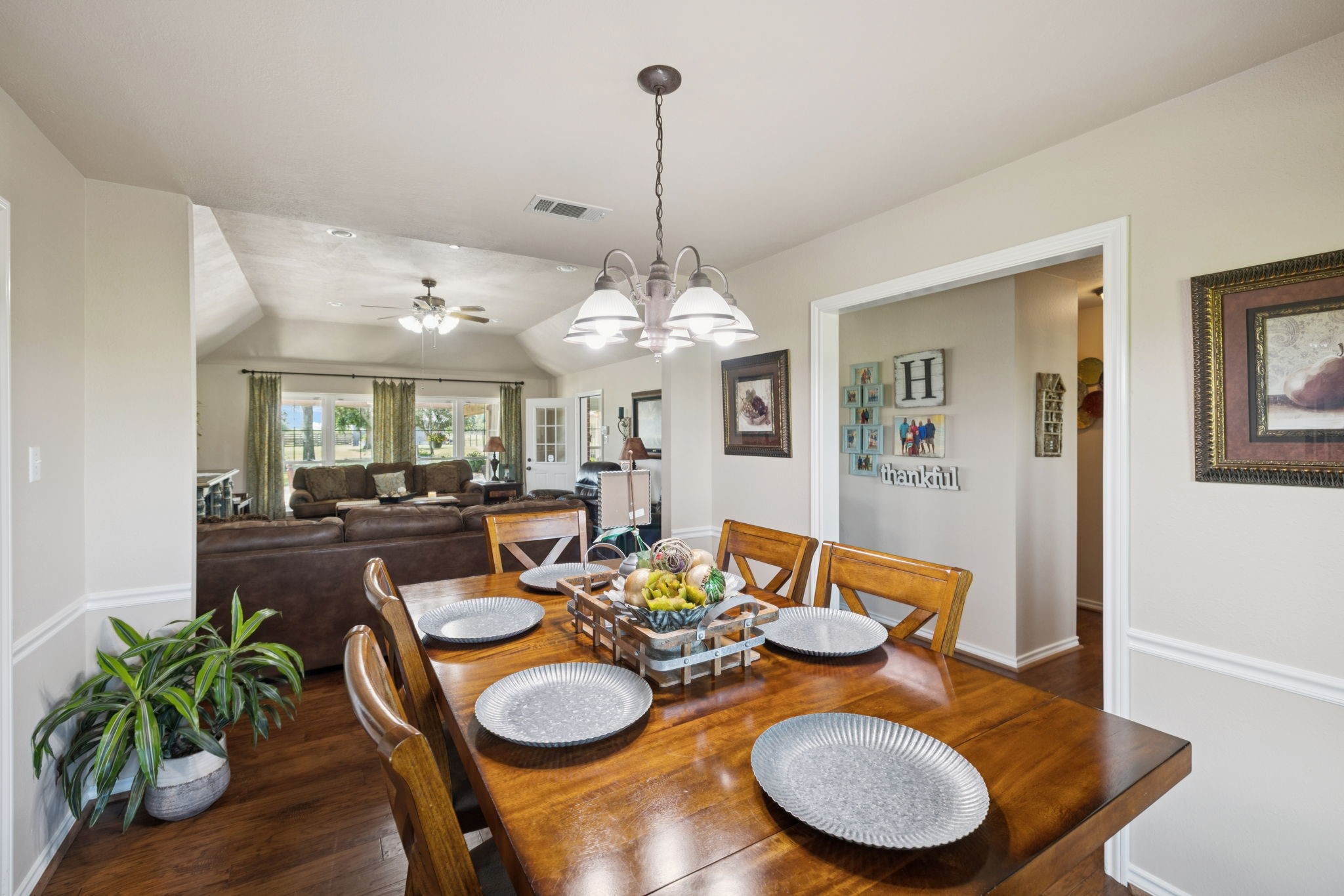 31229 Rochen Road Waller, TX 77484 - Photo 12 of 50 a dining room with furniture a chandelier and wooden floor