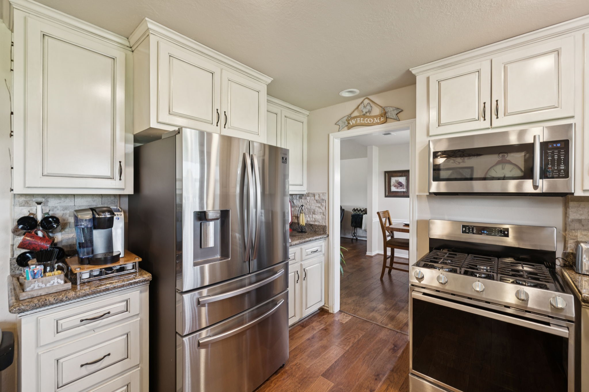 31229 Rochen Road Waller, TX 77484 - Photo 14 of 50 a kitchen with stainless steel appliances granite countertop a refrigerator stove and sink