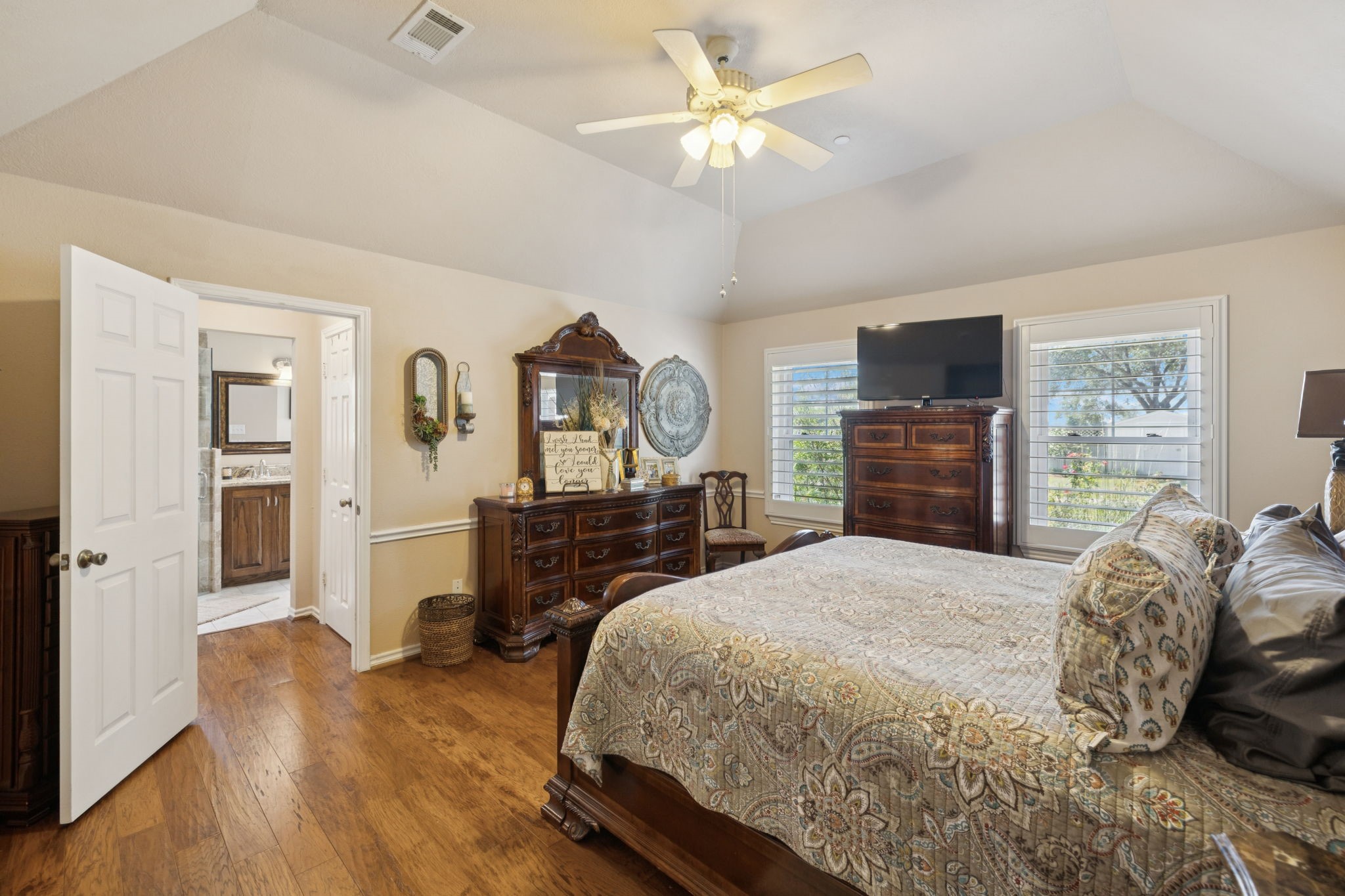 31229 Rochen Road Waller, TX 77484 - Photo 24 of 50 a bedroom with a bed a dresser and flat screen tv