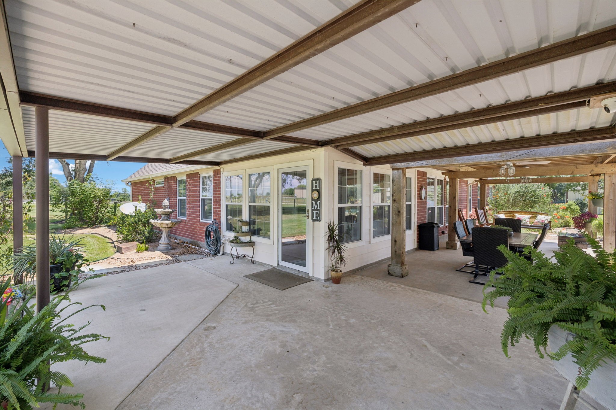31229 Rochen Road Waller, TX 77484 - Photo 31 of 50 a view of a porch with chairs and floor to ceiling window