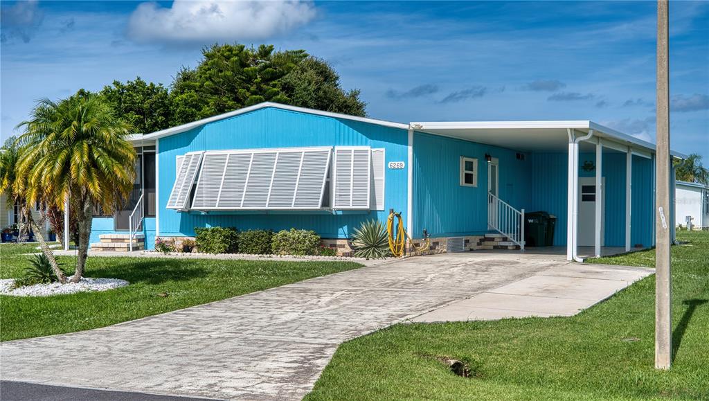 6269 Parakeet Road Englewood, FL 34224 - Photo 1 of 28 a view of a house with a yard plants and palm trees