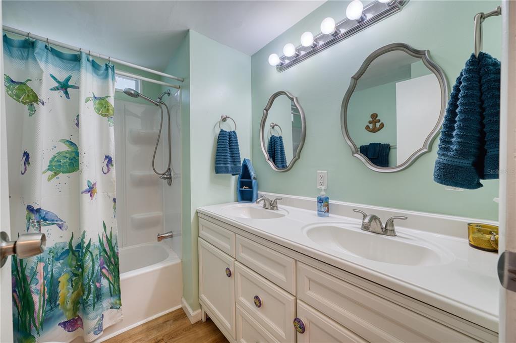 6269 Parakeet Road Englewood, FL 34224 - Photo 11 of 28 a bathroom with a double vanity sink and a mirror