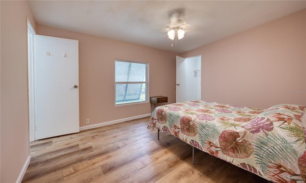 6269 Parakeet Road Englewood, FL 34224 - Photo 12 of 28 a bedroom with a bed chandelier and a window