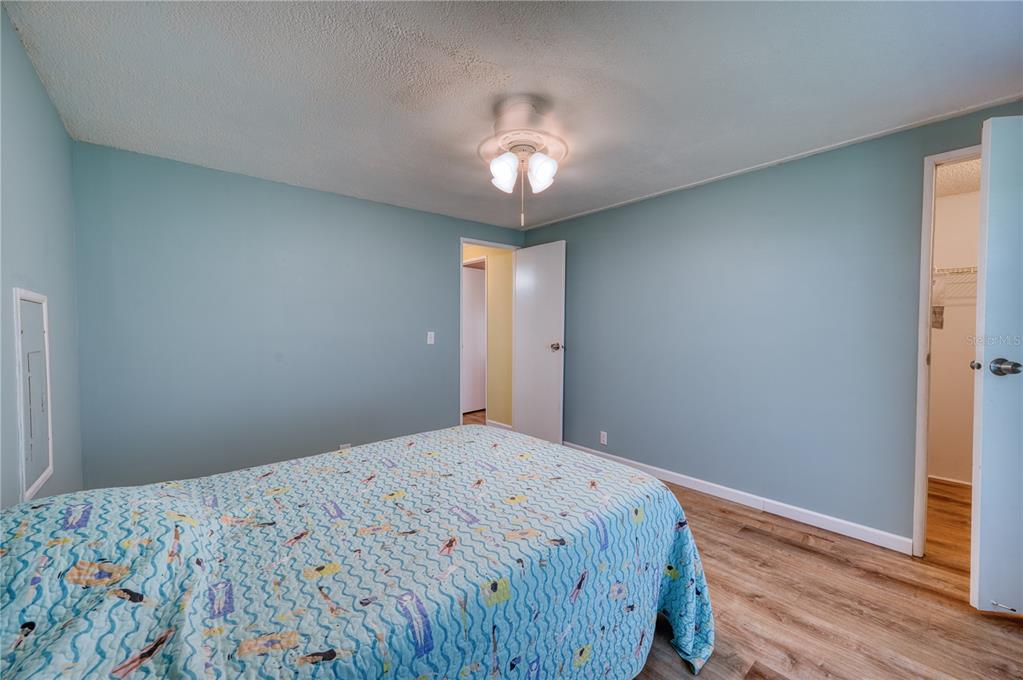 6269 Parakeet Road Englewood, FL 34224 - Photo 14 of 28 a bedroom with a bed and a chandelier