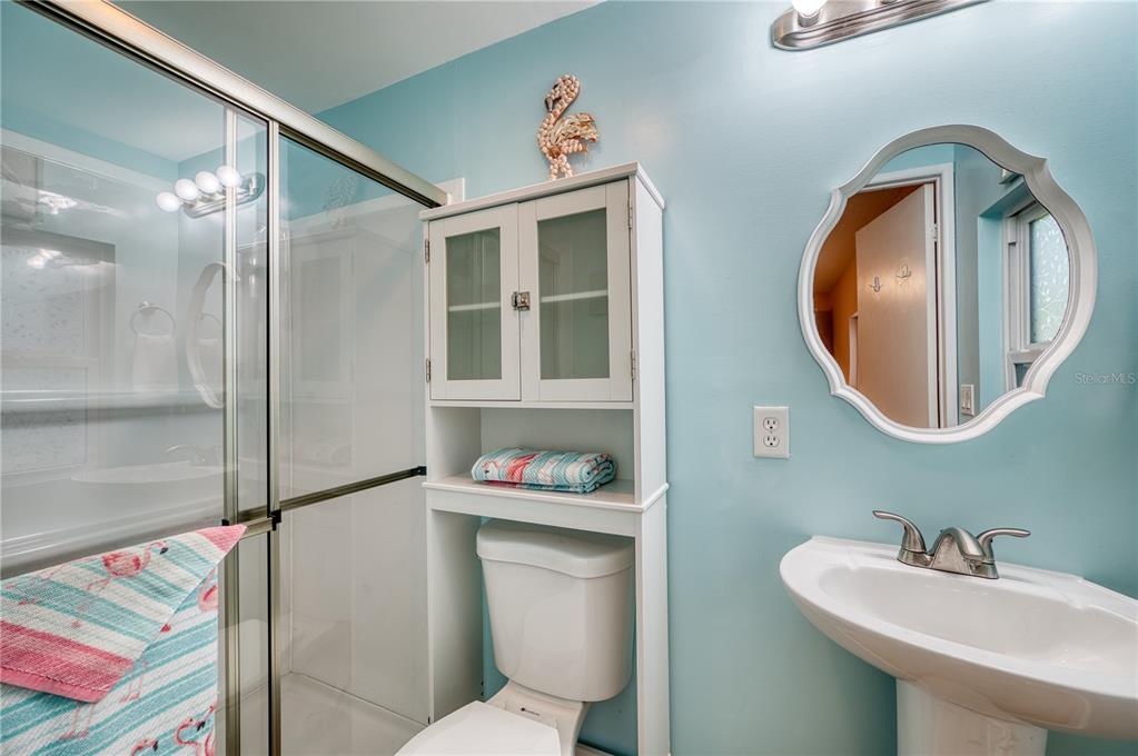 6269 Parakeet Road Englewood, FL 34224 - Photo 17 of 28 a bathroom with a sink mirror vanity and toilet