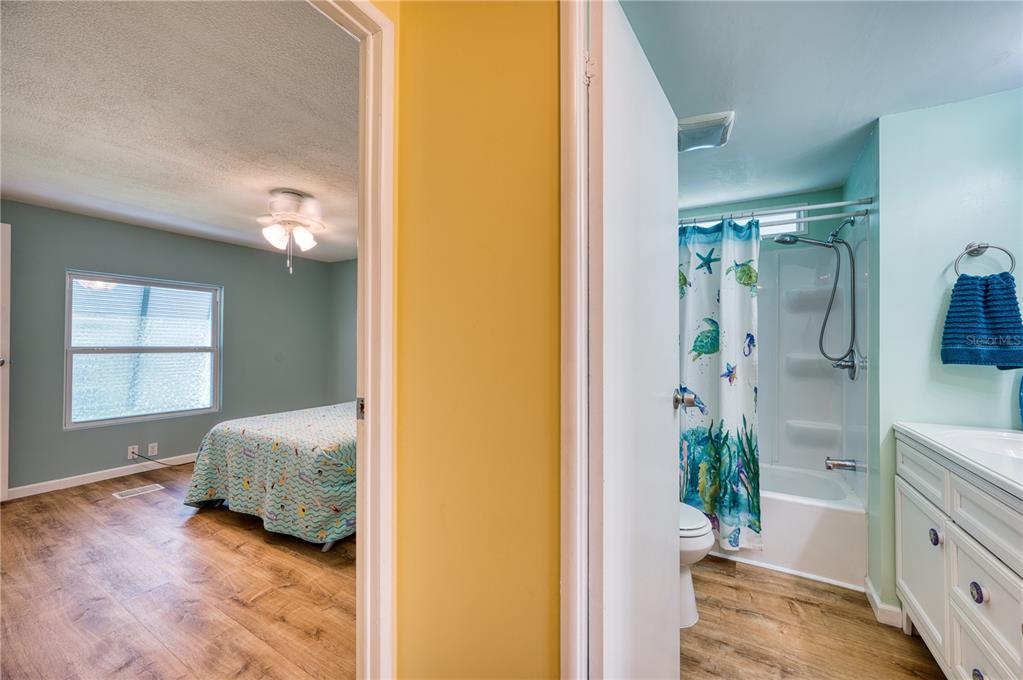 6269 Parakeet Road Englewood, FL 34224 - Photo 19 of 28 a en suite bathroom with a granite countertop shower and a mirror