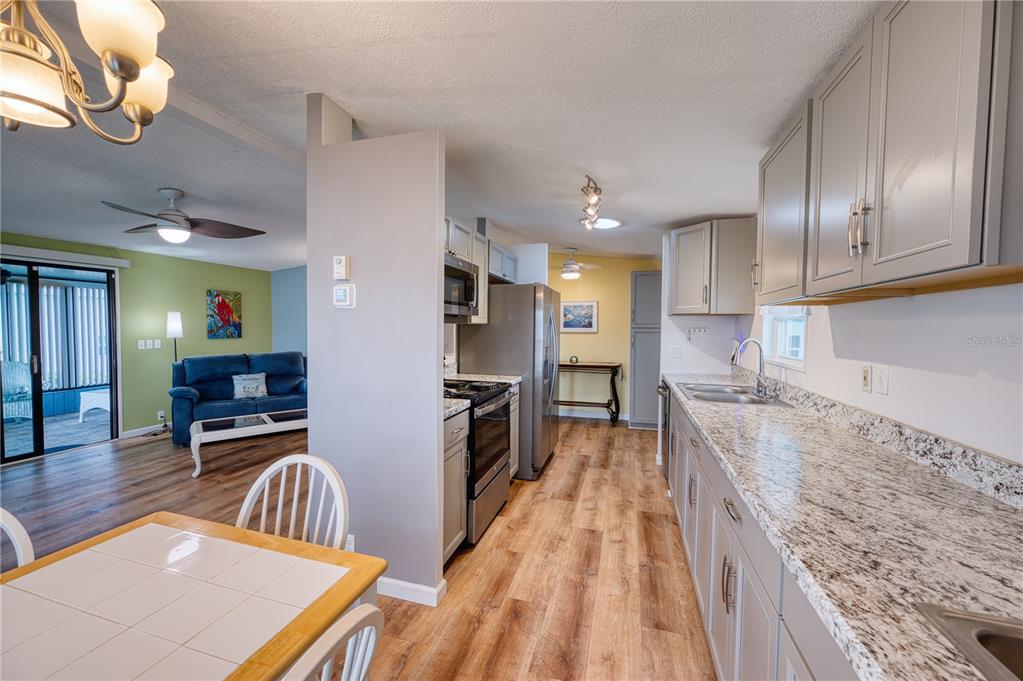 6269 Parakeet Road Englewood, FL 34224 - Photo 3 of 28 a kitchen with granite countertop lots of counter top space and stainless steel appliances