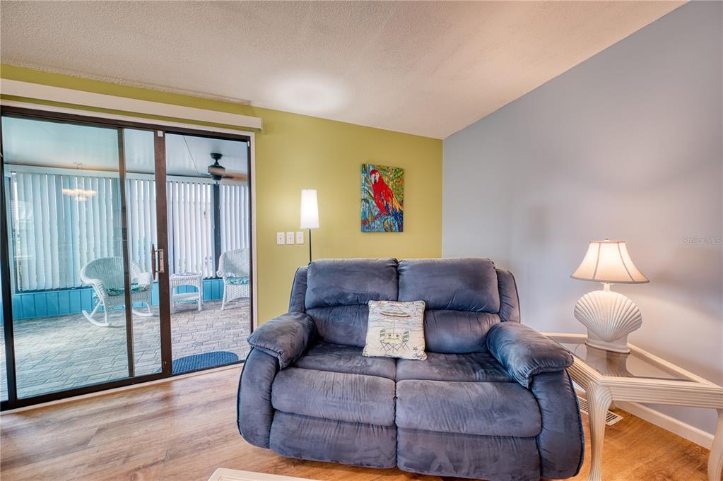 6269 Parakeet Road Englewood, FL 34224 - Photo 8 of 28 a living room with furniture and a floor to ceiling window