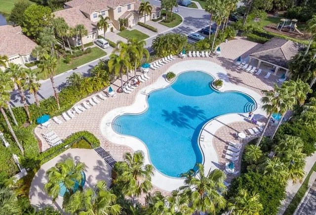 a view of a swimming pool with a flower garden