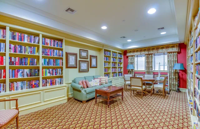 a living room with furniture and a book shelf
