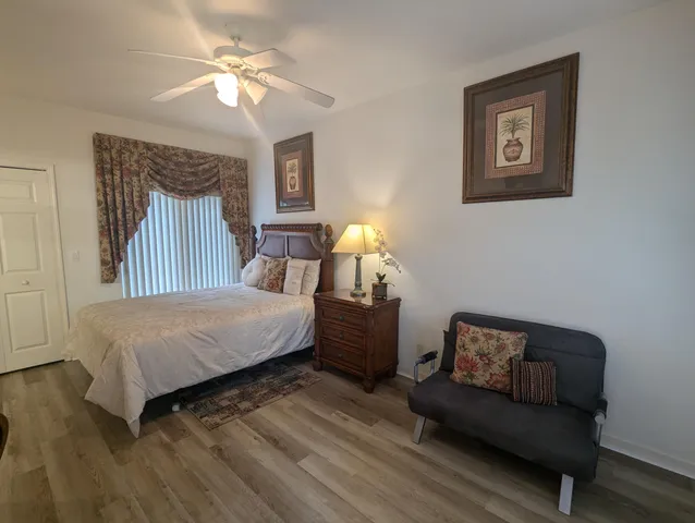 a bedroom with a bed couch and window