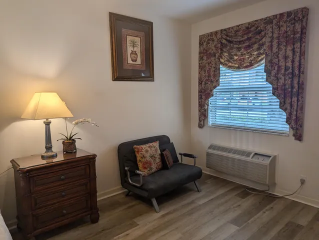 a living room with furniture and a lamp
