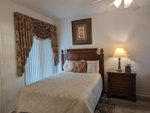 a bedroom with a bed and a lamp