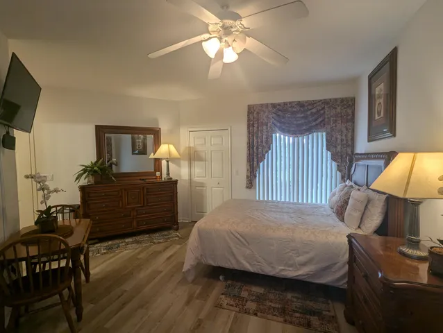 a bedroom with a bed and wooden floor