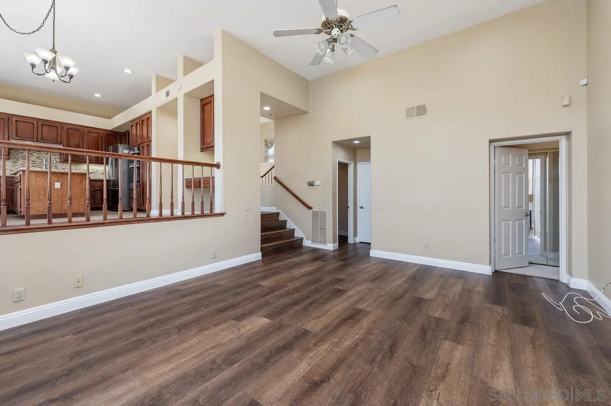 1819 Monarch Ridge Circle El Cajon, CA 92019 - Photo 16 of 60 a view of an empty room with wooden floor and a ceiling fan