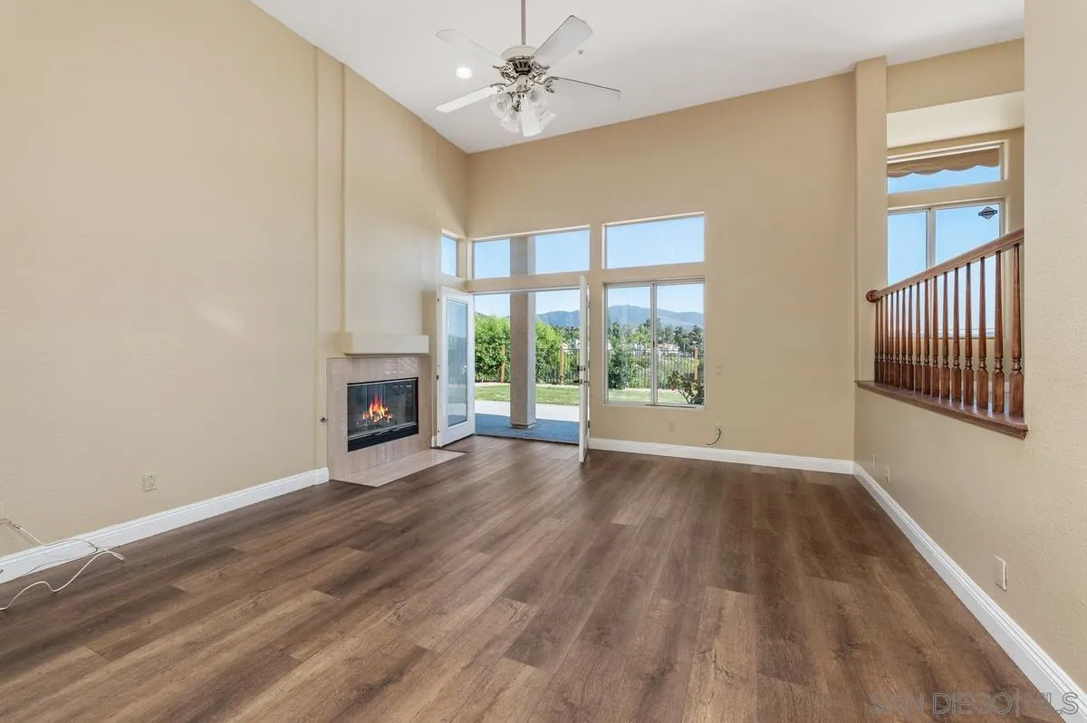 1819 Monarch Ridge Circle El Cajon, CA 92019 - Photo 17 of 60 a view of an empty room with a window and wooden floor